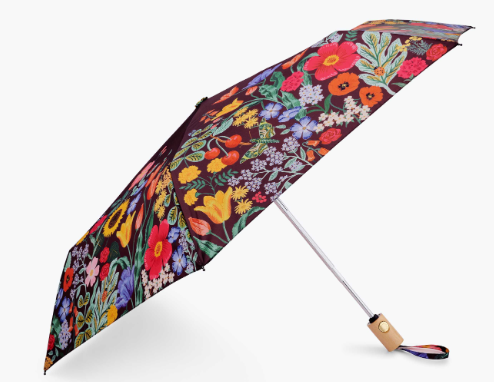 Product image of an expandable umbrella with a wooden handle and floral and black background umbrella design.