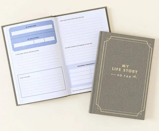 Product image of a journal's front cover that reads "My Life Story So Far" and a second journal opened to the inside, which contains prompts and lined areas on which to record the responses.